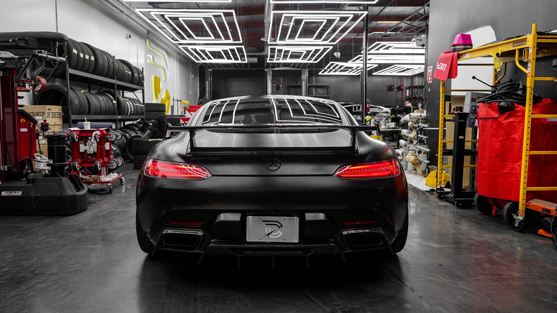 A black performance car in a workshop, shown as illustrative stock photography